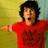 A pixelated image of a person in a red shirt with arms outstretched against a yellow and blue background, overlaid with white text on a red field.