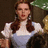 A pixelated image of a woman with long brown hair in pigtails wearing a white blouse and blue dress, next to text reading "Toto" and "I don't think we're in Kansas anymore.".