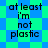Pixelated text 'at least i'm not plastic' repeated four times on a blue-green checkered background with a diamond pattern overlay.