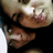 Two figures in close physical proximity with one figure's face near the other's shoulder, rendered in low-resolution pixelated style.