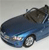 Pixelated blue car with visible headlights and wheels, angled slightly upward against a light gray background.