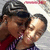 Two people in a close embrace, one wearing red and purple striped clothing against a light background.