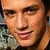 Two side-by-side pixelated images of a person's face showing different expressions, one with eyes open and the other squinting or closing eyes.