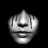 Pixelated grayscale icon of a stylized face with closed eyes, a broad smile, and rounded features against black background.