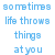 Blue pixelated text on white background with gray rectangle at bottom right, reading "sometimes life throws things at you you choose whether you catch it or not".