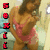 A pixelated figure in a pink top and brown pants stands with arms crossed, side-by-side in showing slight pose variation