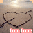 Animated contact sheet showing a sequence of frames where two interlocked heart shapes drawn in sand gradually transform into separate hearts with the text "true love" below them on a beach background.