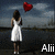 A woman in a white dress stands facing water with a red heart above her head; text 'Alii' appears below.