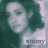 Pixelated image of a person's face with dark hair against a green background, featuring partial text at the bottom.