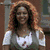 A woman with long curly red hair appears in three distinct poses: smiling forward, turned right, and holding a child.