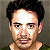 A 50x50 pixel animated contact sheet showing four frames of a celebrity mugshot-style image with green text overlays on a gray background.