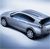 Pixelated silver sedan with dark tinted windows and black wheels, angled slightly left against a light blue gradient background.