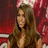 A pixelated image shows a woman with long brown hair and red background, next to a blue oval logo reading 'American Idol' in white script.