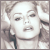 Pixelated grayscale image of a person with short hair, closed eyes, and mouth slightly open in neutral expression.