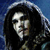 Pixelated static image of a person with long dark hair wearing a hooded garment against a blue background.