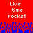 Red background with white pixelated text "Live time rocks!!" repeated twice, blue pixelated crowd at bottom.