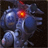 Pixelated blue and silver robot with glowing red and yellow chest light against dark background.