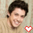 A person with dark curly hair and a light brown shirt appears in two side-by-side frames, each featuring a pixelated heart symbol below the figure.
