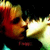 Pixelated static image of two figures kissing with warm color palette and dark background.