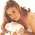 A pixelated image shows a person with long brown hair holding a white rabbit against a light background.