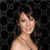 Pixelated image of a person with dark hair against a black background, showing a smiling expression with visible teeth.