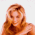 Pixelated image of a person with long light brown hair against white background, next to green with bright green text