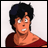 Pixelated anime-style character with dark hair and red top on left, adjacent to black background with white text "Anime IM" above smaller "COM" on right.