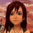 Pixelated anime-style portrait of a person with dark brown hair and blue eyes against a pinkish-orange gradient background.