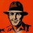 Pixelated portrait of a person wearing a dark wide-brimmed hat and light-colored shirt against an orange background.