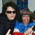 Two people pose together; one wears dark clothing and sunglasses, the other wears a blue and red outfit with a patterned hat, all in a pixelated style.