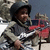 Pixelated image of a child in a space suit holding a red object, with text overlay reading "Adam when he was four years old" on a black background.