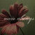 A pixelated flower with brown and pink petals, a dark center, and green background.