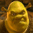 Pixelated golden figure with large rounded head, small eyes, and broad nose, set against dark brown background with scattered lighter brown patches.