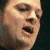 Pixelated close-up of a person's face showing eyes, nose, mouth, and partial cheek with visible pixelation and color blending.