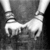 Two white hands in a handshake pose against a dark gray background, rendered with low-resolution pixelation.
