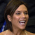 Pixelated close-up of a person with dark hair smiling broadly, showing teeth, against a dark background with blue and white elements.