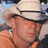 Pixelated image of a person wearing a light-colored cowboy hat and orange shirt with red text reading 'Kenny Chesney !!!!!!!!' on the right side.