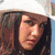 Four distinct portrait images of a woman with varying hair colors and accessories arranged in a