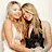 Two women with long blonde hair embrace; one wears a white top, the other dark clothing. Green text reads 'OriginalIcons.com' on a dark green background.