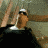 Animated sequence of a figure in a white cap and dark shirt against a muted background, showing motion of arms and head turning.