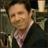 four and four shows a person in a dark suit and light purple shirt smiling, with the smile widening from top-left to bottom-right