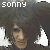 Pixelated image of a person with dark hair and white triangular shapes, showing text 'sonny' at top left and heart symbol on right side.