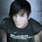 Pixelated portrait of a person with short dark hair wearing a black shirt against a gradient background.