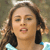 Static pixelated image of a person with long dark hair wearing a light blue top, visible against a muted background.