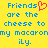 Yellow background with blue pixelated text reading 'Friends are the cheese to my macaroni ly.' and a pink heart symbol replacing the 'o' in 'Friends'.