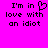 A bright pink background displays black pixelated text reading "I'm in love with an idiot" with a heart symbol replacing the 'o' in 'love' on the left side.