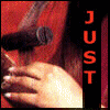 A four- shows a person with long dark hair holding a microphone, wearing red clothing and rings on fingers