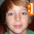 Pixelated close-up of a person with light brown hair and fair skin, wearing a green top, with an orange graphic element on the right side.