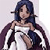 Pixelated image of a figure with long dark hair wearing a white top and dark purple cape-like garment, arms crossed in front of chest.