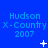 Blue background with repeated text 'Hudson X-Country 2007' and animated white pixel symbols changing across three